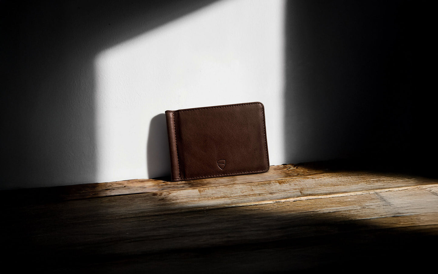 Vaultskin BROMPTON brown leather wallet under artistic light and shadow, minimalist RFID blocking wallet for everyday carry